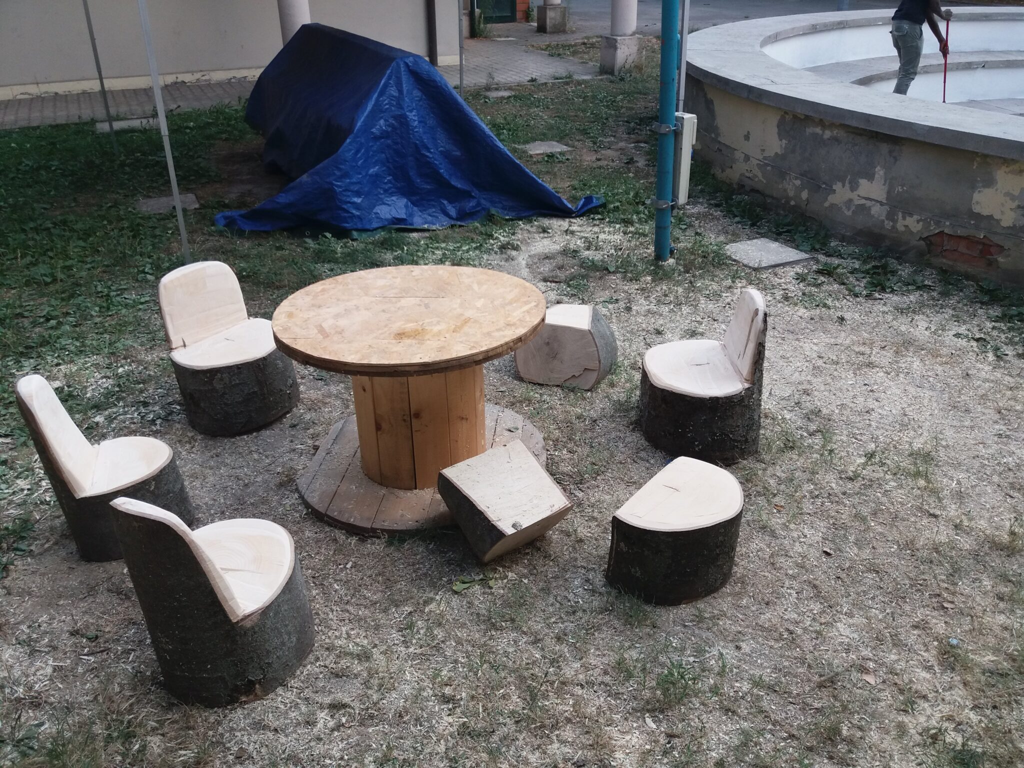 Un'immagine che ritrae legna, mobilia, mobili da esterno, tavolo da esterno e materiale naturale.